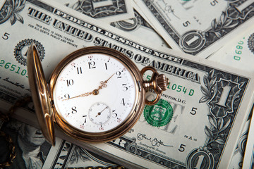 gold watch and dollar bills