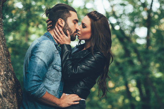 Beautiful young woman kissing handsome man