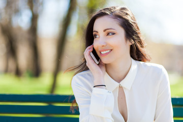     Smiling young woman using a mobile phone