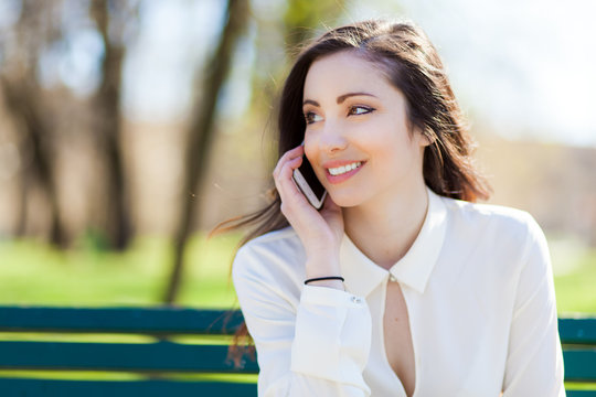     Smiling young woman using a mobile phone