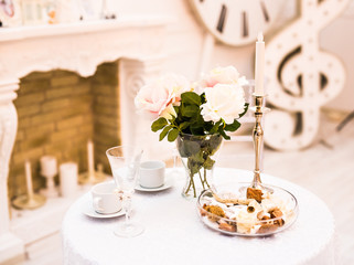 table with vase and two cups