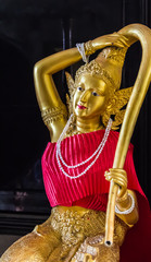 Statue of Phra mae thorani twisting her hair , the buddhist goddess of earth - a statue in  temple area in Thailand