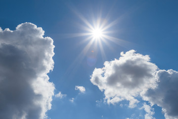 Naklejka na ściany i meble blue sky sun through a clouds