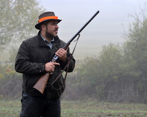 hunter with rifle waiting for pheasant