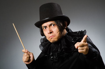 Funny magician wearing cylinder hat