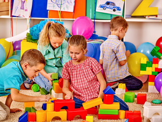 Group kids game blocks on floor .