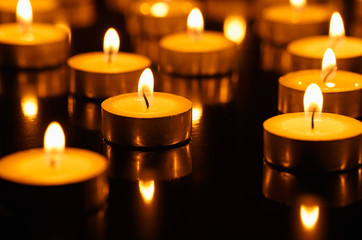 Many burning candles with shallow depth of field