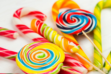 Colorful candy on white wooden background