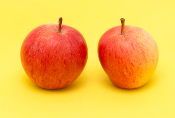 ripe apples on a yellow background