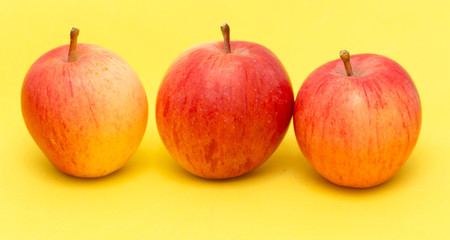ripe apples on a yellow background