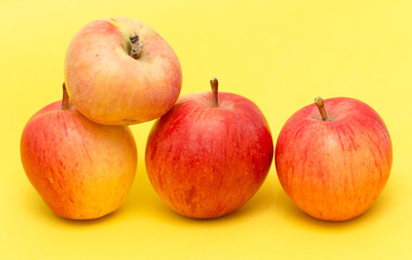 Fototapeta na wymiar ripe apples on a yellow background
