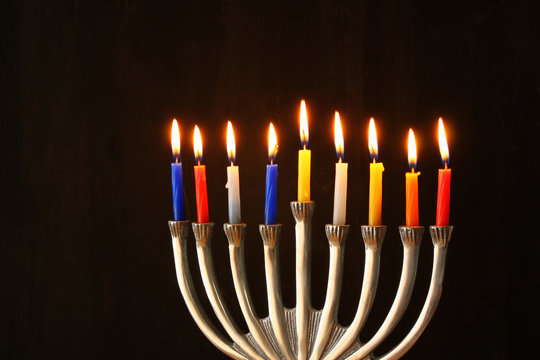 Image of jewish holiday Hanukkah background with menorah (traditional candelabra) and Burning candles
