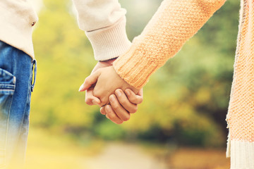 Couple holding hands in the park