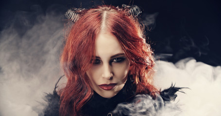 devil girl smiling in smoke