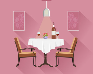  Flat style round restaurant table for two with white cloth, wine glasses, bottle of wine, plate and vase with flowers. Restaurant interior with dinner table, chairs, lamp and pictures.