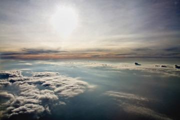 sun and clouds from an airplane window