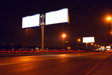 Big white billboard on lighting night street