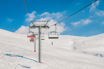 Ski lifts durings bright winter day