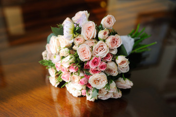 a bridal bouquet of roses on the table