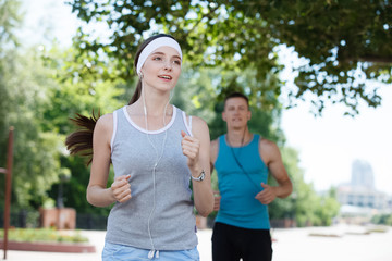 Young couple jogging in park at morning. Health and fitness.