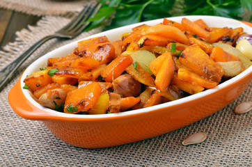 Pumpkin stew with vegetables on rustic table