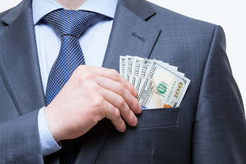 Businessman putting money in the breast pocket