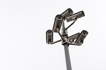 Security cctv surveillance camera in front of blue sky