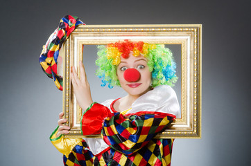 Clown with picture frame in funny concept