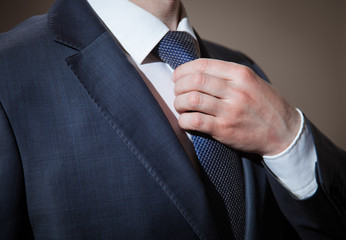 Businessman adjusting his tie