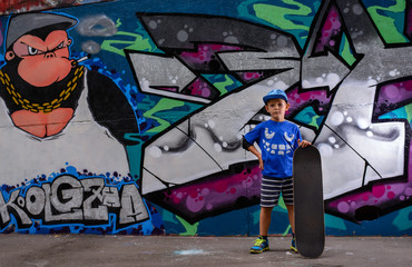 Confident youngster posing with his skateboard