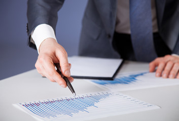 Unrecognizable businessman proposing to examine a new project