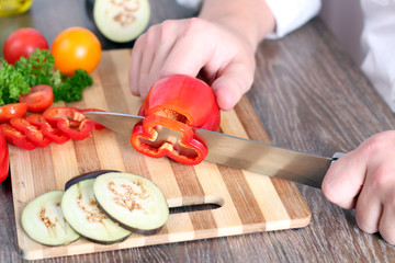 food, family, cooking and people concept - Man chopping paprika