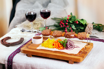 meat skewers wooden board still life in a Christmas New Year holiday meal wine