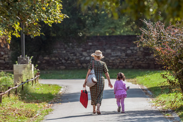 Grandmother and granddaughter walking