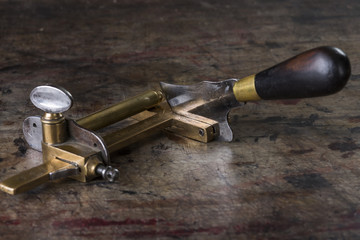 Fototapeta na wymiar Leather goods craftsman's tool on a dirty work bench