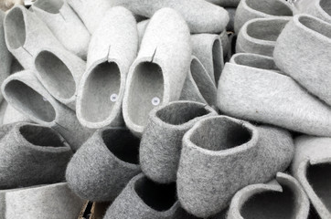 Pile of gray traditional felt slippers