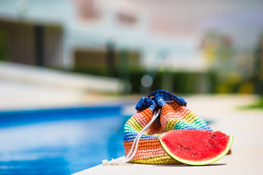 Colorful beach bag and tasty red watermelon at summer picture