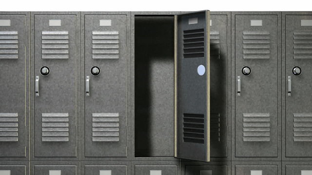 A slow low angle pan view of a stack of metal school lockers with combination locks and doors shut