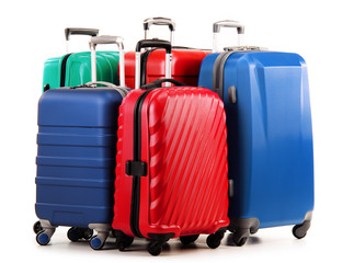 Five plastic suitcases isolated on white