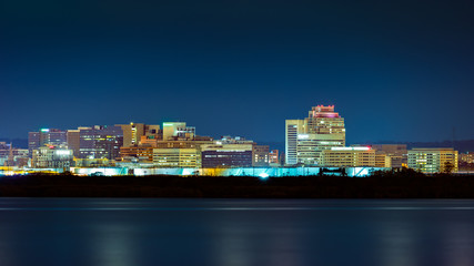 Wilmington skyline by night, viewed from New Jersey, across the Delaware River. Wilmington is the largest city in the state of Delaware. - obrazy, fototapety, plakaty