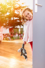 christmas morning, a girl opens a door.Christmas tree & gifts 