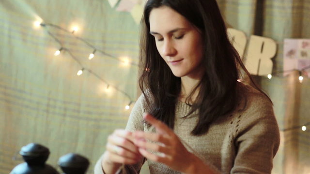 Young Woman Wrapping Christmas Gifts At Home