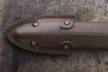 Close up photo of a dark brown leather belt made by leather goods craftsman