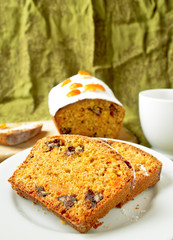 Cake with orange candied peel, chocolate drops and citrus drink 