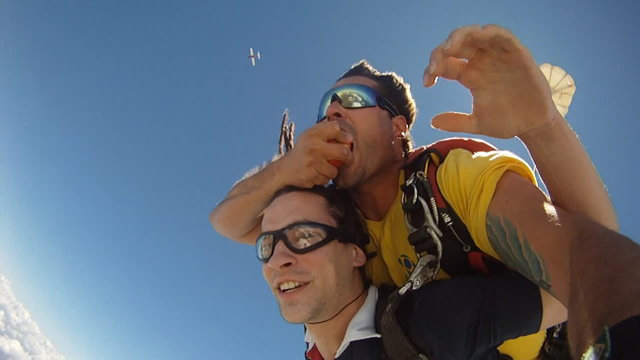 Skydivers eating a apple