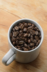 Roast organic coffee beans in white mug