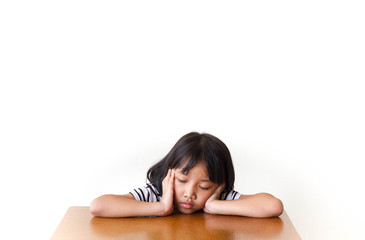 Bored children girl sitting at the table