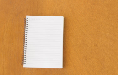 Blank notebook on the wooden table. View from above