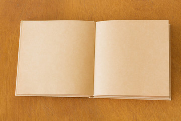 Blank notebook on the wooden table. View from above