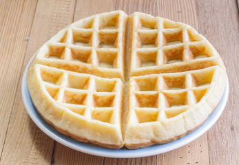 Full waffle with blue dish on the wooden background